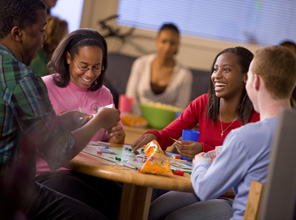 Students at a circular table smiling